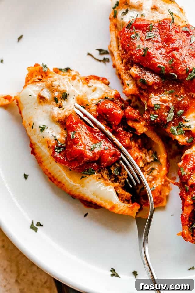 cutting into stuffed pasta shells with a fork