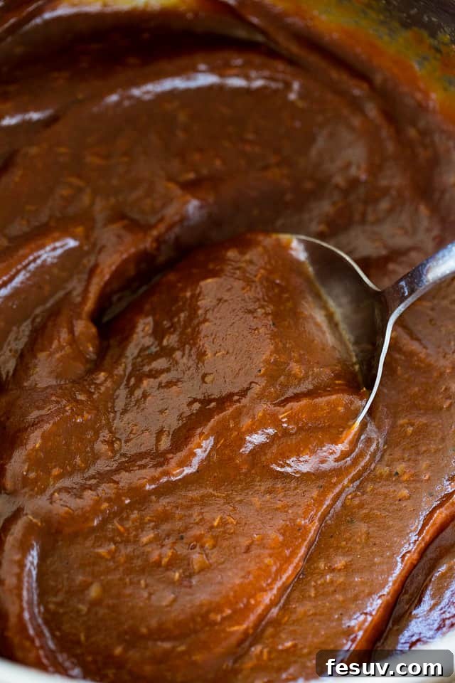 Mixing through Apple Butter with silver spoon