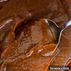 Mixing through Apple Butter with silver spoon