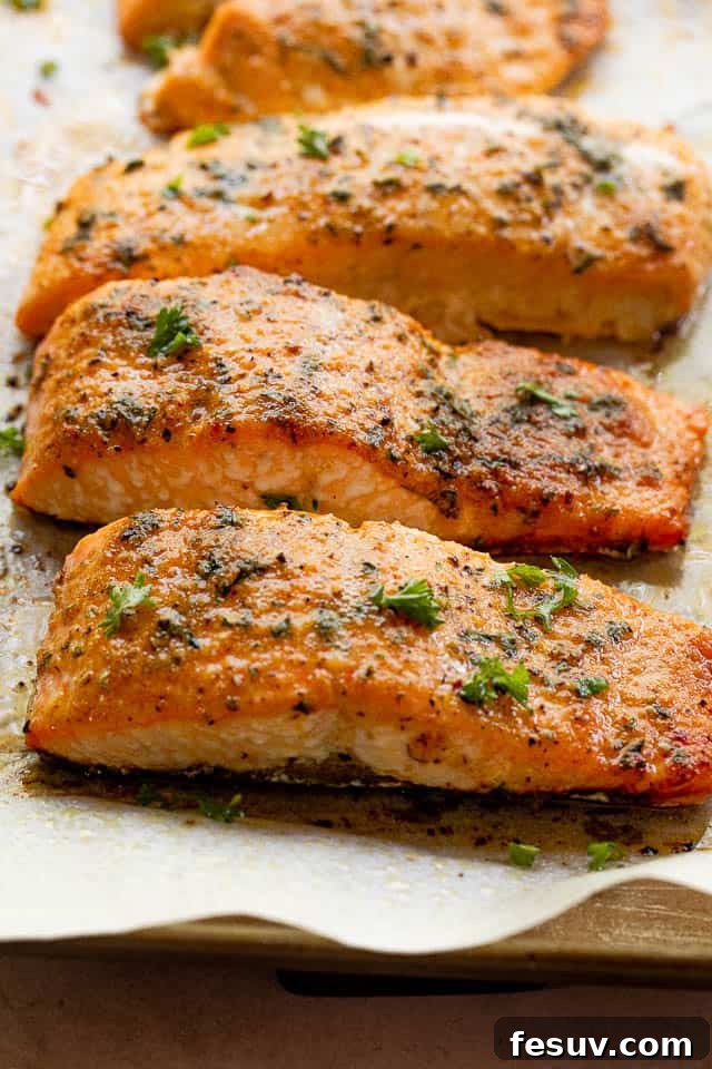 Side shot of perfectly cooked Old Bay seasoned salmon fillets, showcasing their flaky texture and golden-brown crust, ready to be enjoyed.