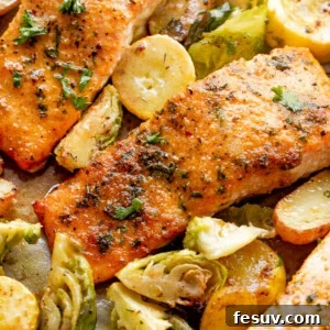 Overhead shot of roasted salmon fillets with brussel sprouts and yellow squash