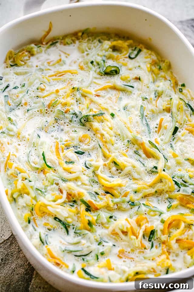 overhead shot of prepped casserole with spiralized zucchini and squash
