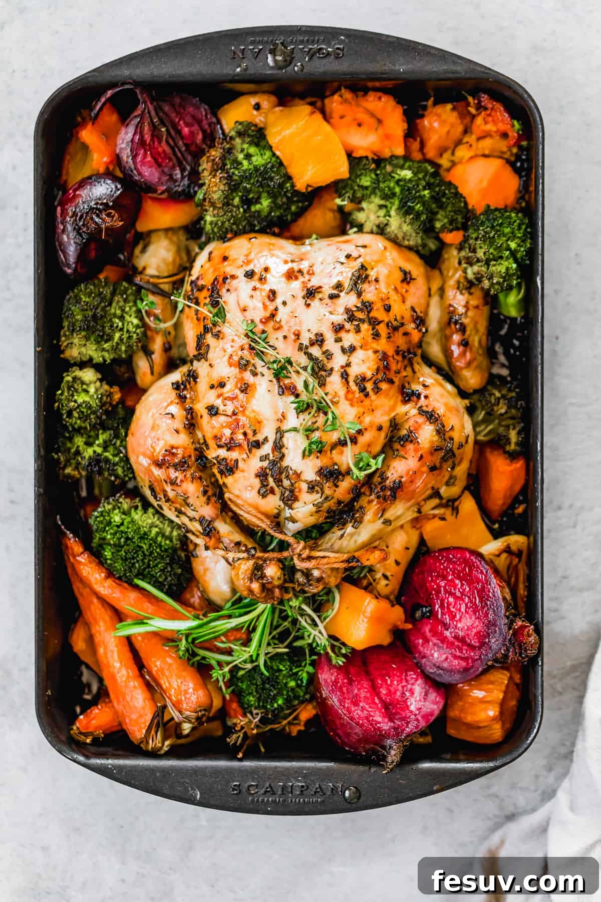 Golden Autumn Roast Chicken with Rustic Root Vegetables 6 Whole roast chicken with fall vegetables on a sheet pan, ready to serve.