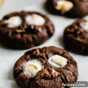 Four Chocolate Marshmallow Cookies on a Sheet of Parchment
