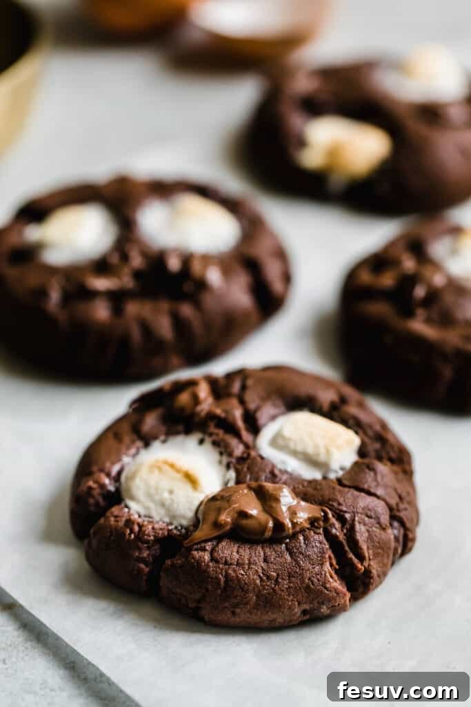 Four Chocolate Marshmallow Cookies on a Sheet of Parchment paper