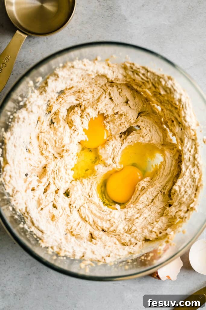 Cookie Batter and Eggs in a Glass Mixing Bowl, ready for dry ingredients