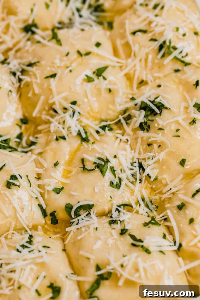 A detailed close-up of cheesy dinner roll dough balls, generously seasoned with vibrant fresh parsley