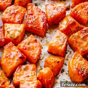 overhead shot of chopped sweet potatoes on parchment paper