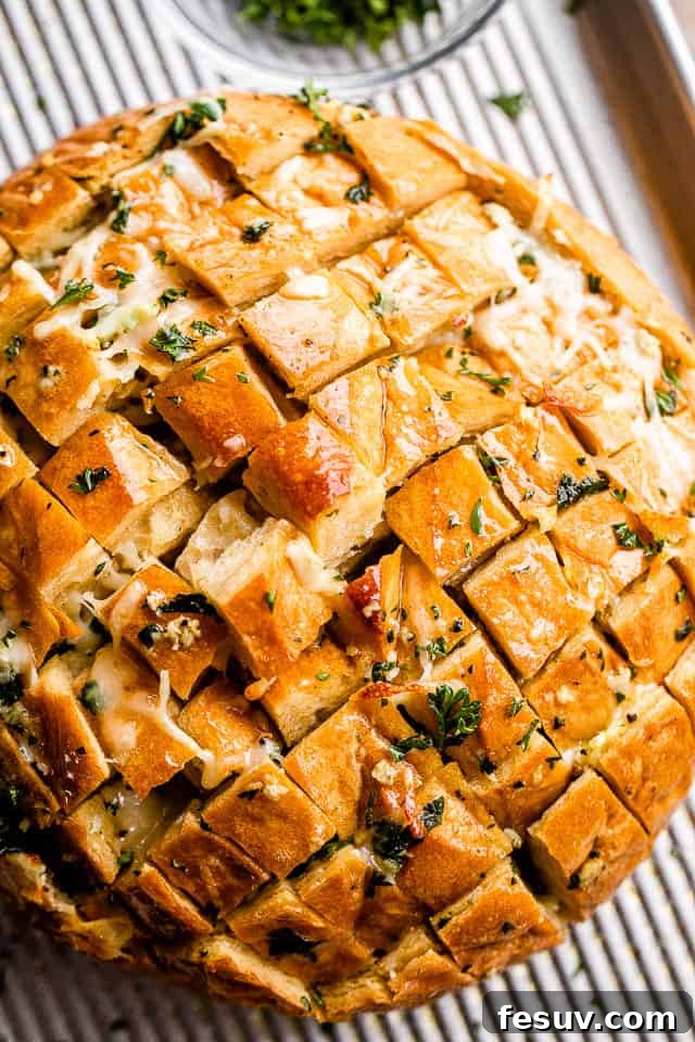 Ultimate Cheesy Garlic Sharing Loaf 6 overhead shot of a fully baked cheesy garlic pull apart bread ready to be served