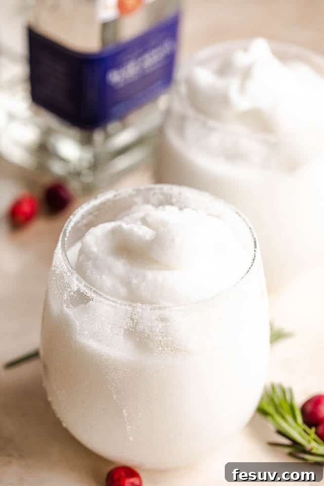 Two pristine white frozen coconut margaritas in elegant glasses, garnished with lime and cranberries, with a bottle of silver tequila subtly placed in the background, signaling premium ingredients.