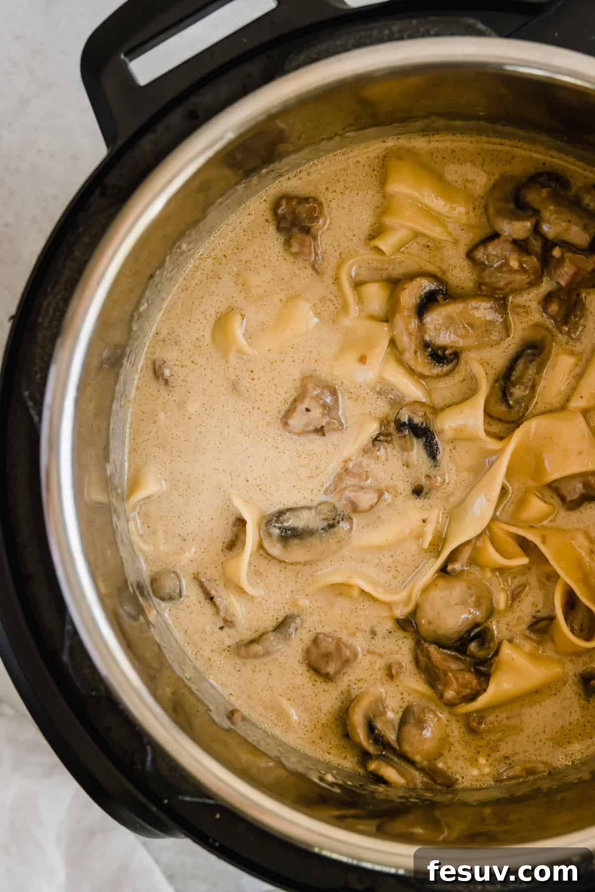 Effortless Creamy Instant Pot Beef Stroganoff 11 A Pressure Cooker Filled with Beef and Mushroom Stroganoff, before the final creamy touches.