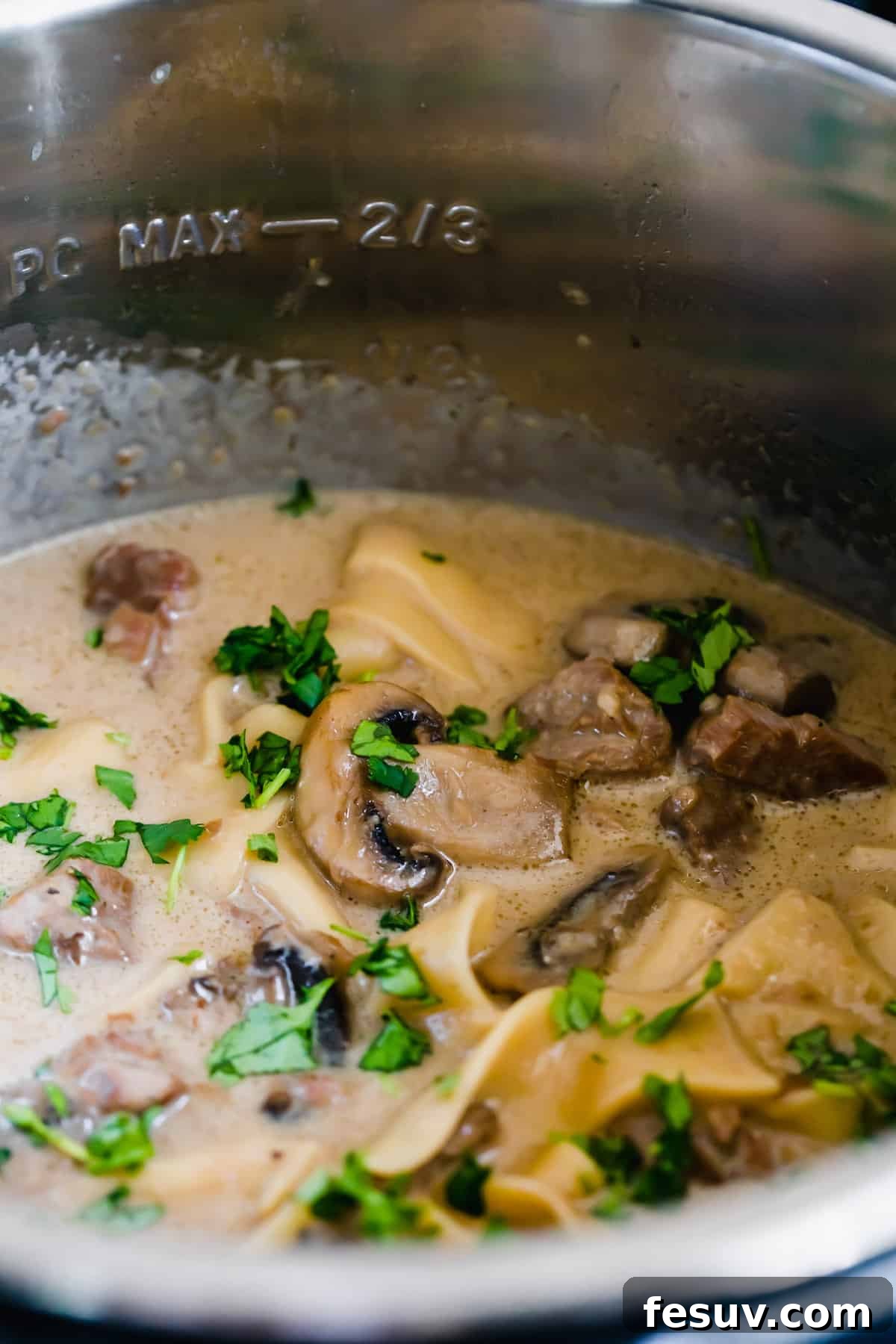 Effortless Creamy Instant Pot Beef Stroganoff 12 Creamy Beef Stroganoff Inside of a Pressure Cooker, showcasing the final, luxurious sauce.
