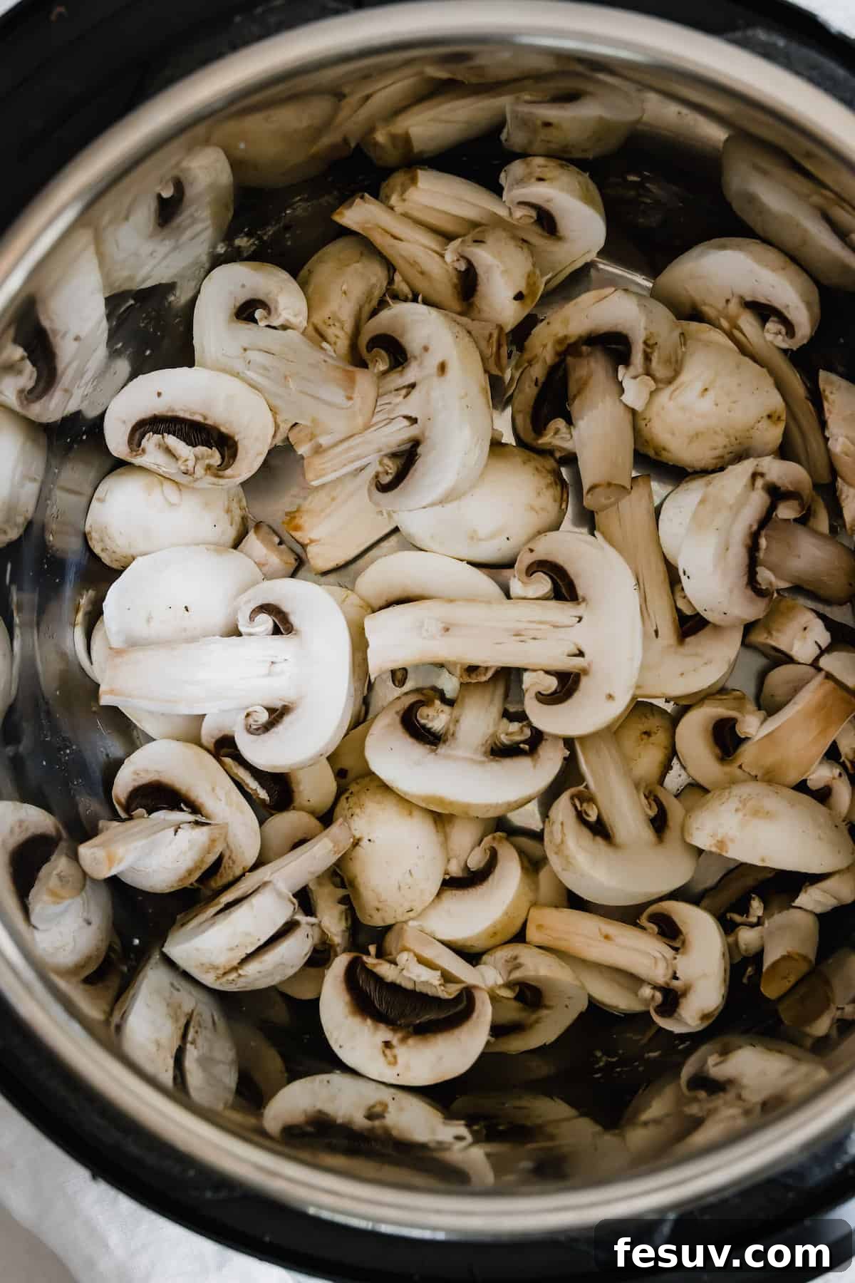 Effortless Creamy Instant Pot Beef Stroganoff 9 An Instant Pot Bowl Filled with Sliced Mushrooms, sautéing to golden perfection.