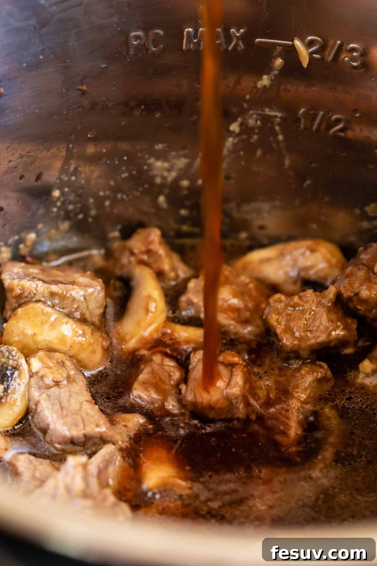 Effortless Creamy Instant Pot Beef Stroganoff 10 Beef Broth Being Added to the Instant Pot Bowl, creating the flavorful base.