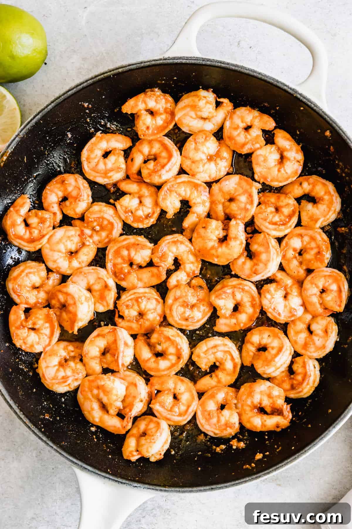 My easy shrimp tacos recipe with Asian cabbage slaw is guaranteed to be a new favorite. The classic flavors of a warm shrimp taco blend amazingly with the fresh, crunchy slaw in warm tortillas! A Skillet Filled with Cooked Shrimp
