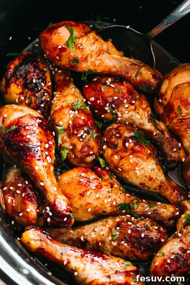 close up of chicken drumsticks glazed with honey sriracha sauce