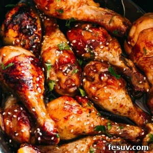 close up of chicken drumsticks glazed with honey sriracha sauce