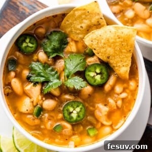 overhead shot of white soup bowls with chicken chili