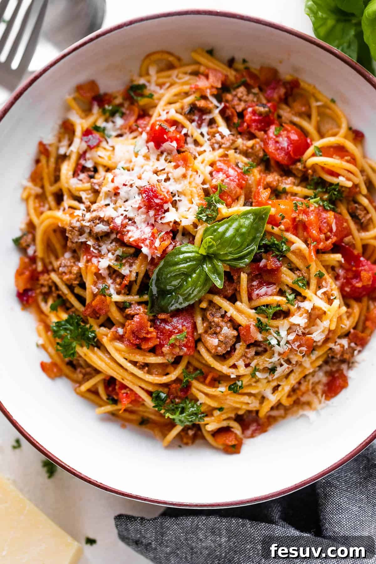 One-Pot Wonder Spaghetti 3 overhead shot of a spaghetti bowl topped with tomatoes and basil