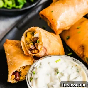 A Plate of Egg Rolls with a Glass Dish of Dipping Sauce