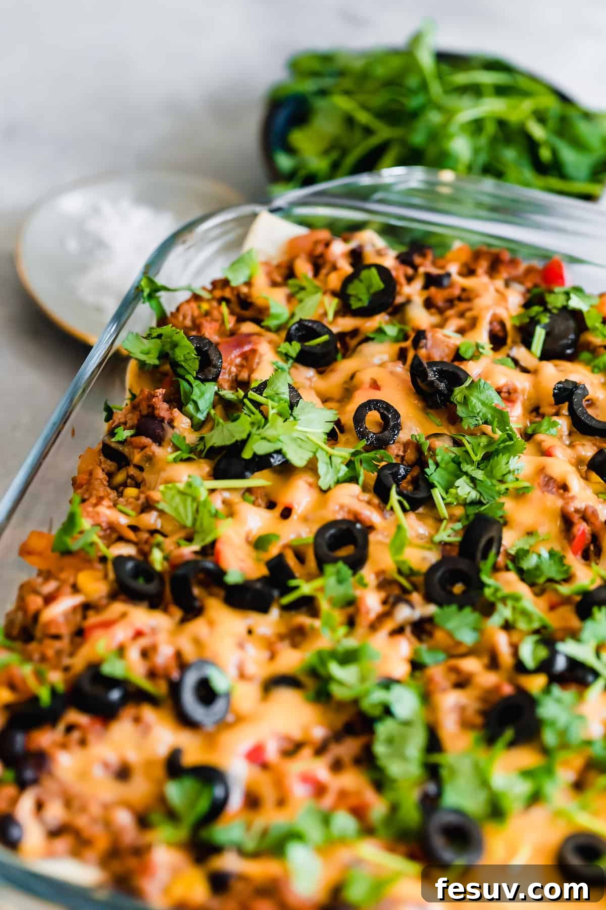 Enchilada Lasagna 4 A freshly baked pan of Mexican Lasagna, garnished with chopped parsley and black olives, ready to serve.