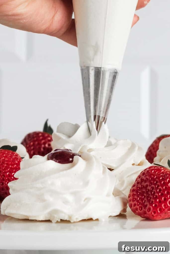 A hand piping whipped cream