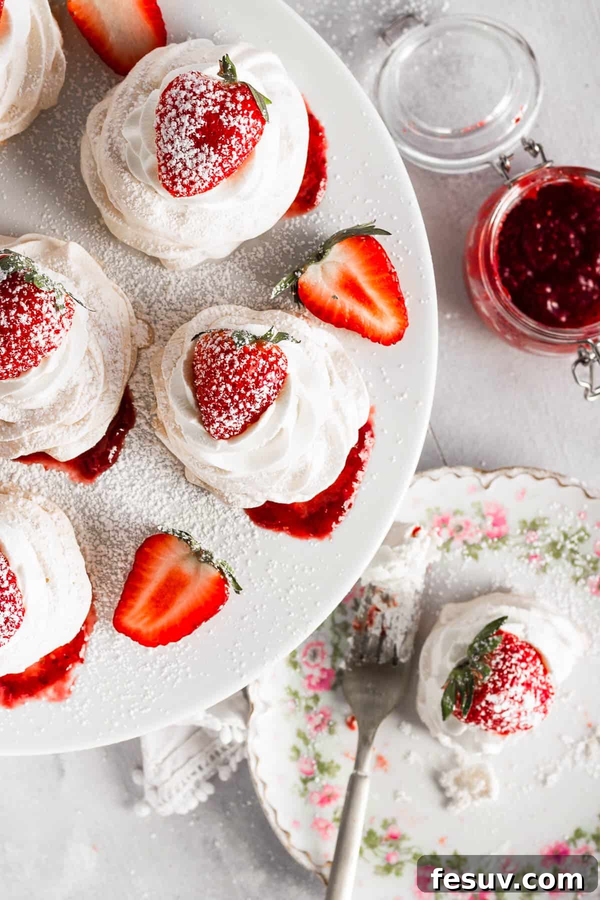 overhead shot of Pavlovas topped with strawberries and sugar