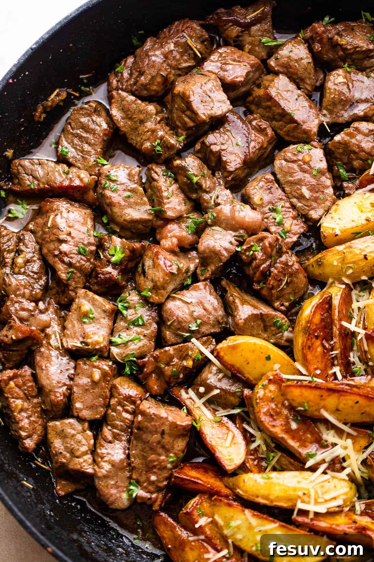 Close-up of perfectly browned garlic steak bites, glistening with marinade, ready to be served