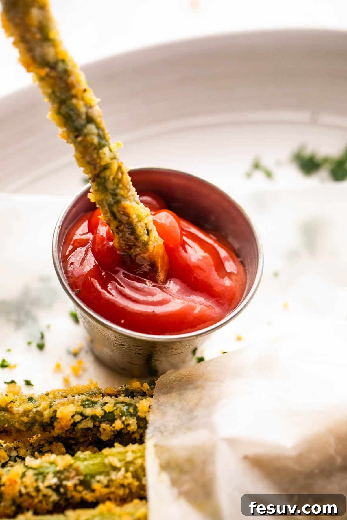 dipping asparagus fries in ketchup