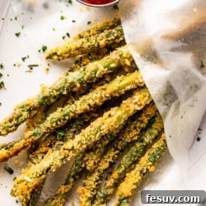 overhead shot of baked parmesan panko asparagus fries served with ketchup on the side