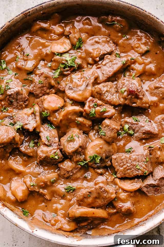 Seared golden brown beef tips with luscious mushroom gravy, ready to be served.
