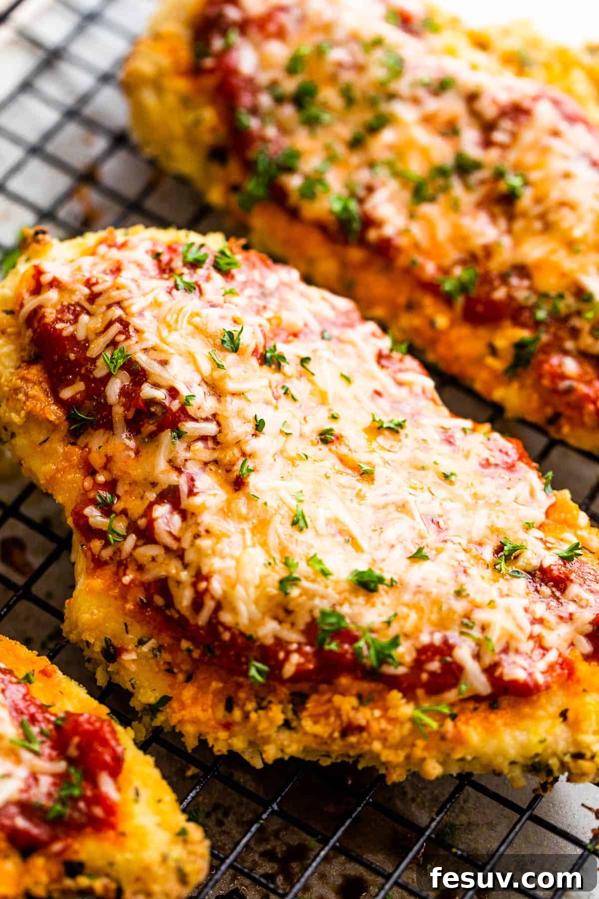 Crispy Air Fryer Chicken Parmesan 3 A Close-Up Shot of a Piece of Chicken Parmesan on Top of a wire rack