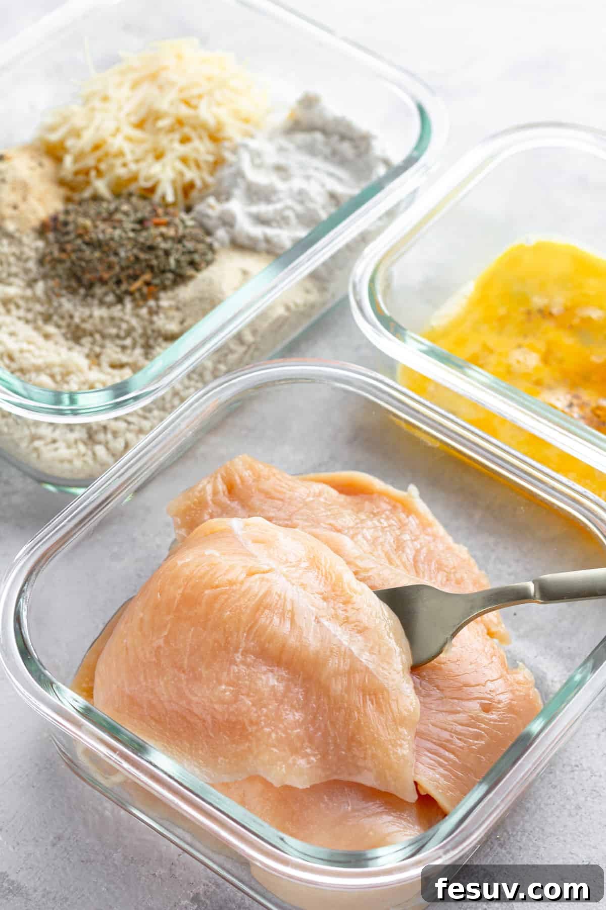 Crispy Air Fryer Chicken Parmesan 5 Three Glass Containers on a Counter – One Containing Raw Chicken, One Containing the Egg Mixture and One Containing the Un-Combined Breading Mixture