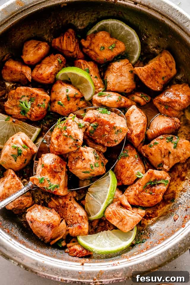 The easiest and most flavorful Taco Chicken Bites recipe for quick weeknight dinners. Skillet filled with golden-brown taco chicken bites, garnished with fresh cilantro and lime wedges.