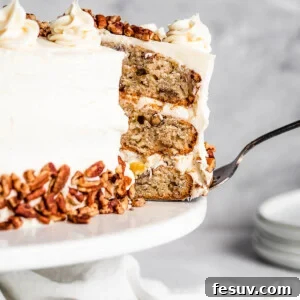 A Slice of Frosted Layer Cake Being Lifted From a Cake Stand