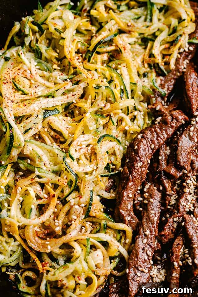 This flank steak with zucchini noodles is the flavorful, summertime dinner you’ve been looking for! Even better, it's ready in 20 minutes! Close up of flank steak and zucchini noodles.