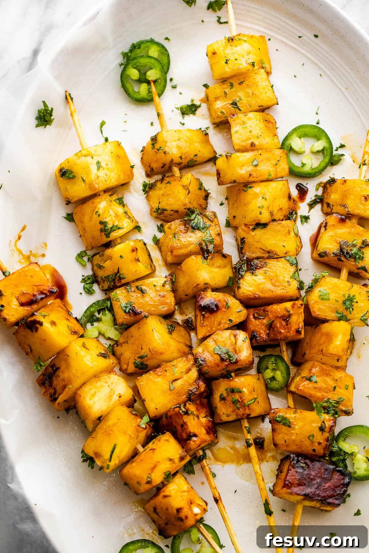 Tequila-Kissed Grilled Pineapple 3 five skewers with pineapples