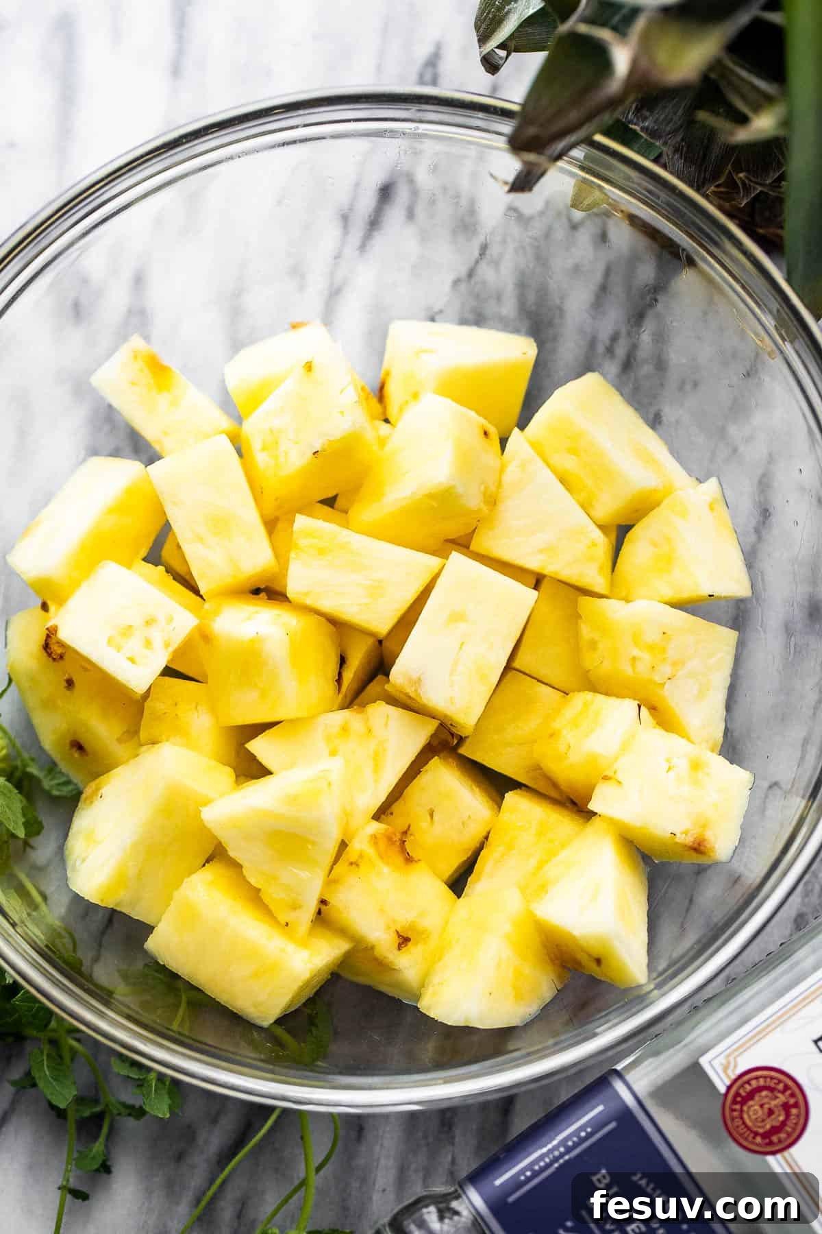 Tequila-Kissed Grilled Pineapple 4 diced fresh pineapple in a glass bowl