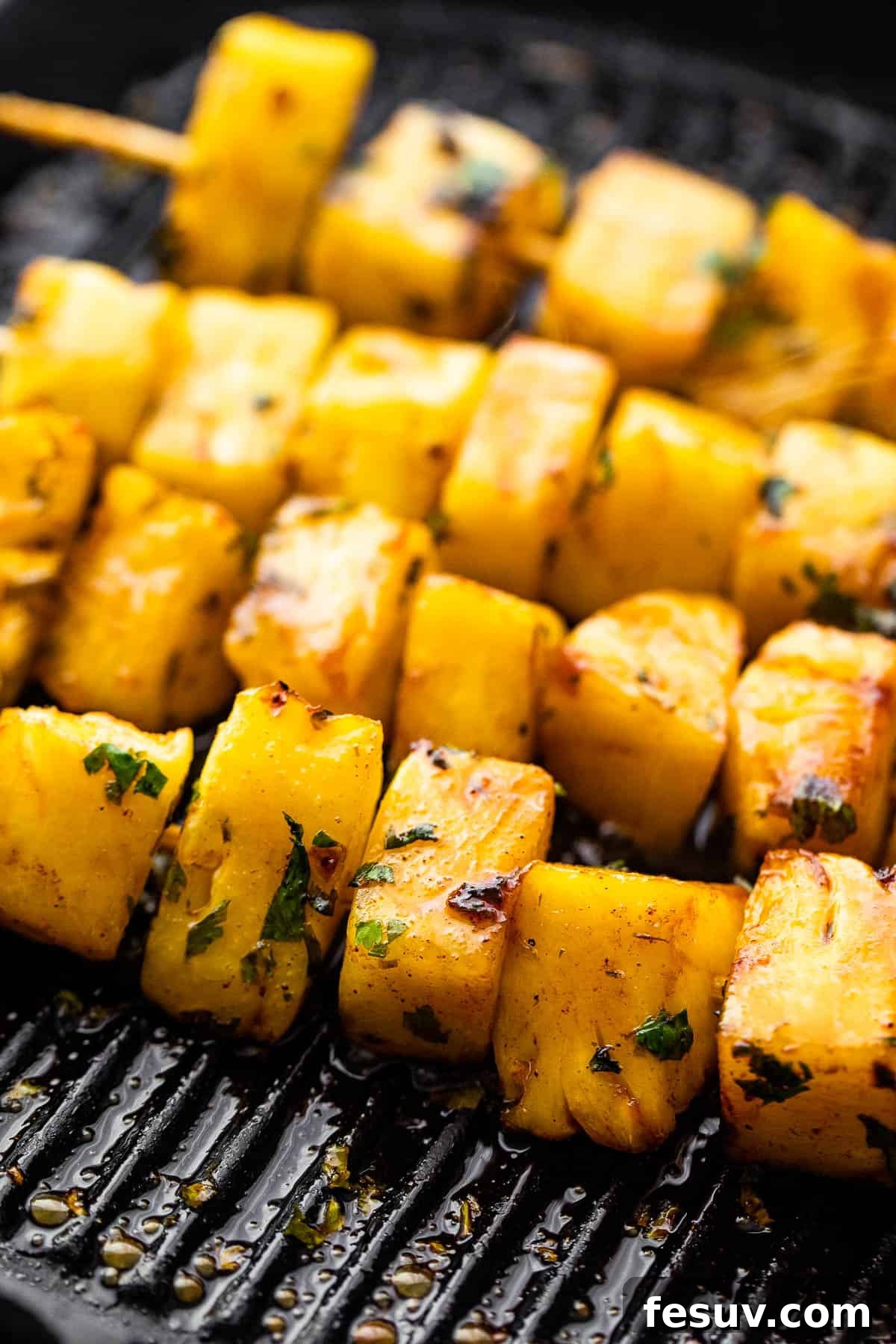 Tequila-Kissed Grilled Pineapple 6 grilling pineapples on skewers