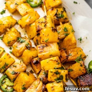 grilled tequila pineapple skewers served on a plate