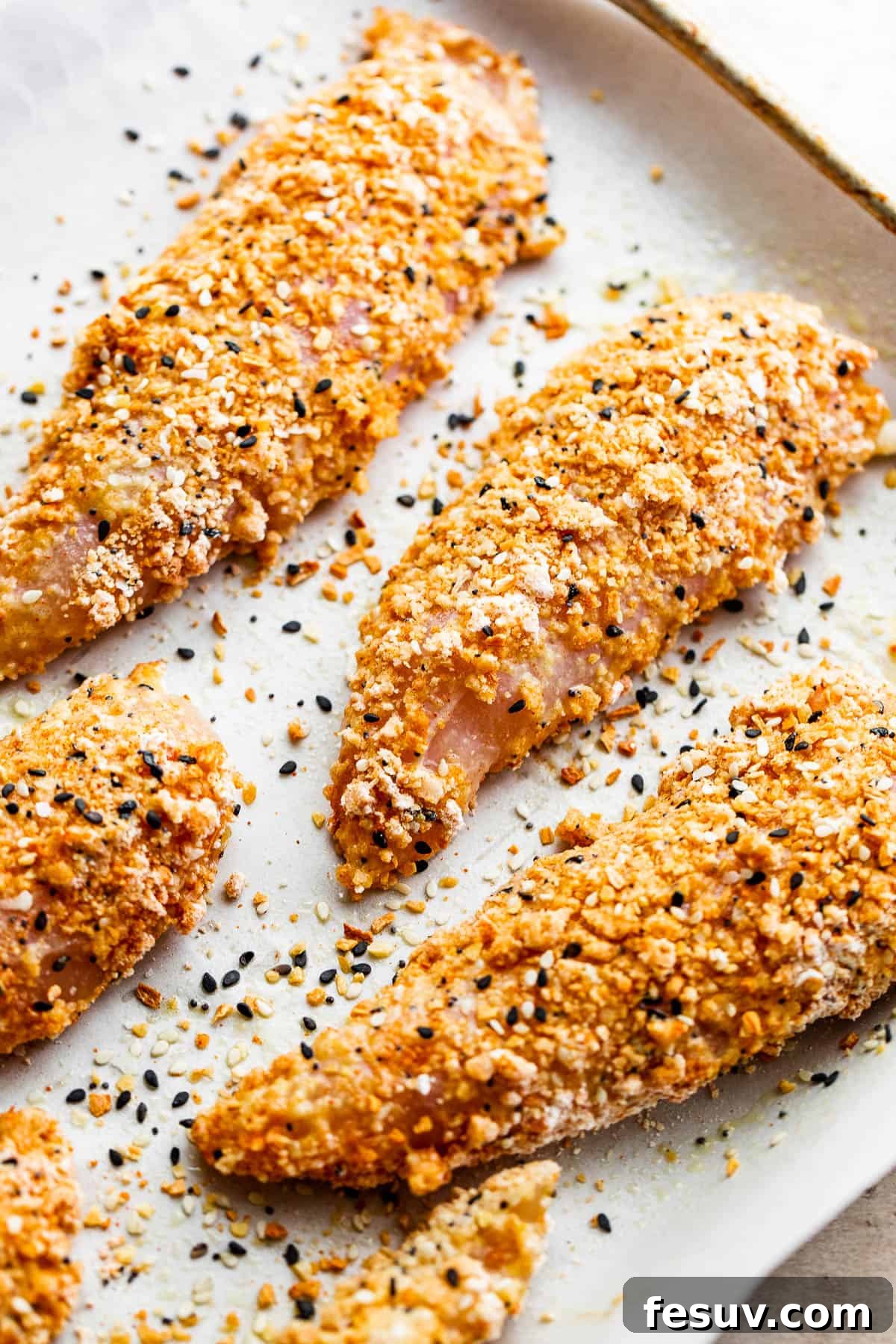 raw chicken tenders covered with everything bagel seasoning mix