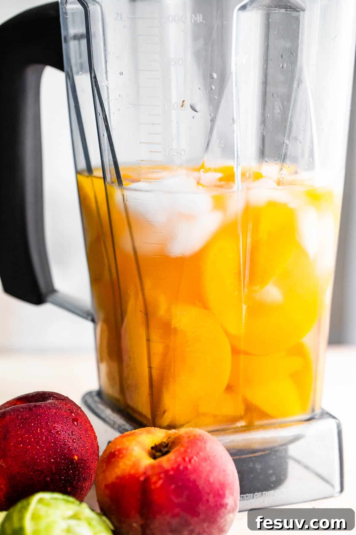 fresh peaches, rum, and ice in a blender