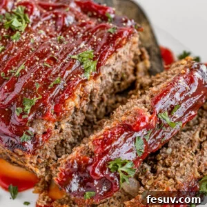 Quick and Delicious Meatloaf 2 Meatloaf Covered in Barbecue Sauce on a White Serving Platter
