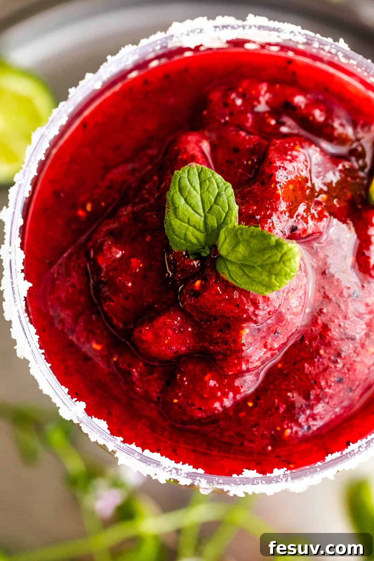 Blended Berry Margaritas 3 overhead close up shot of Frozen Berry Margarita served in a margarita glass and garnished with mint