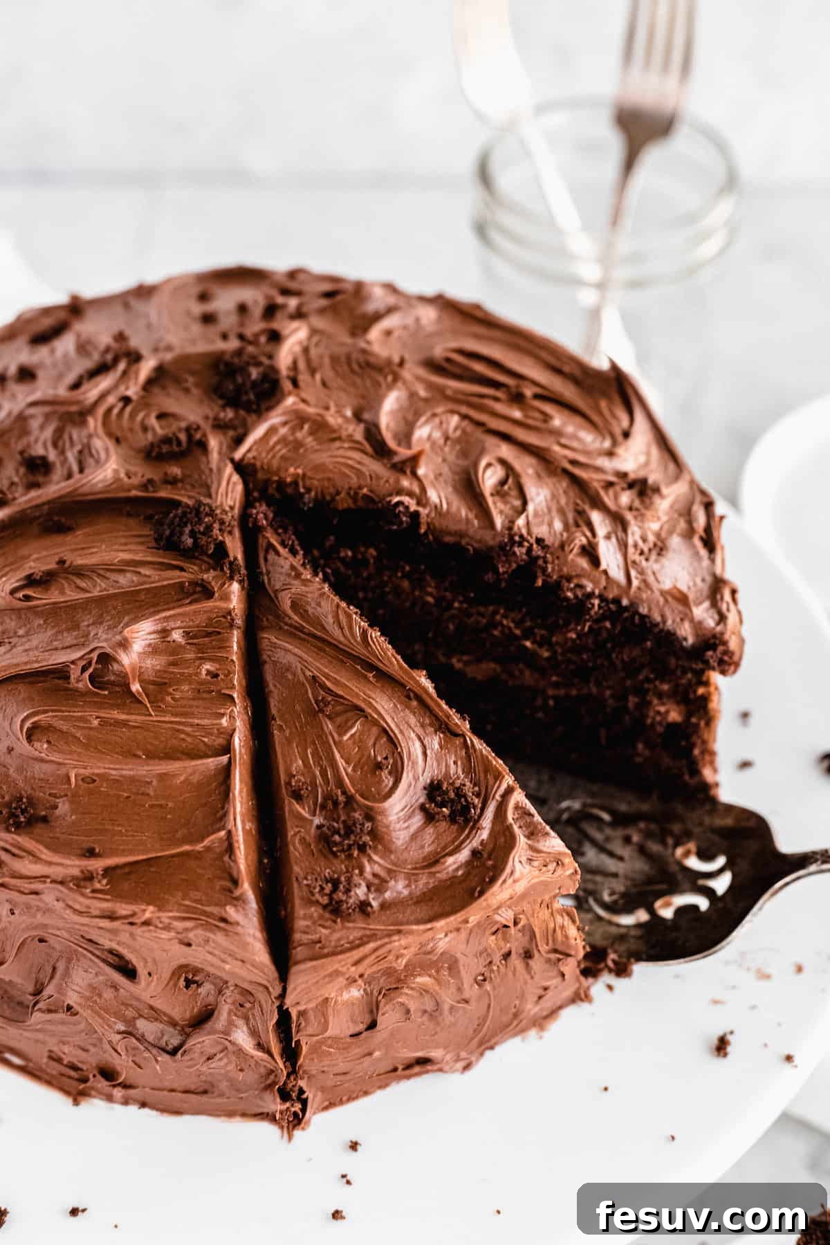 A whole frosted chocolate cake, rich and inviting