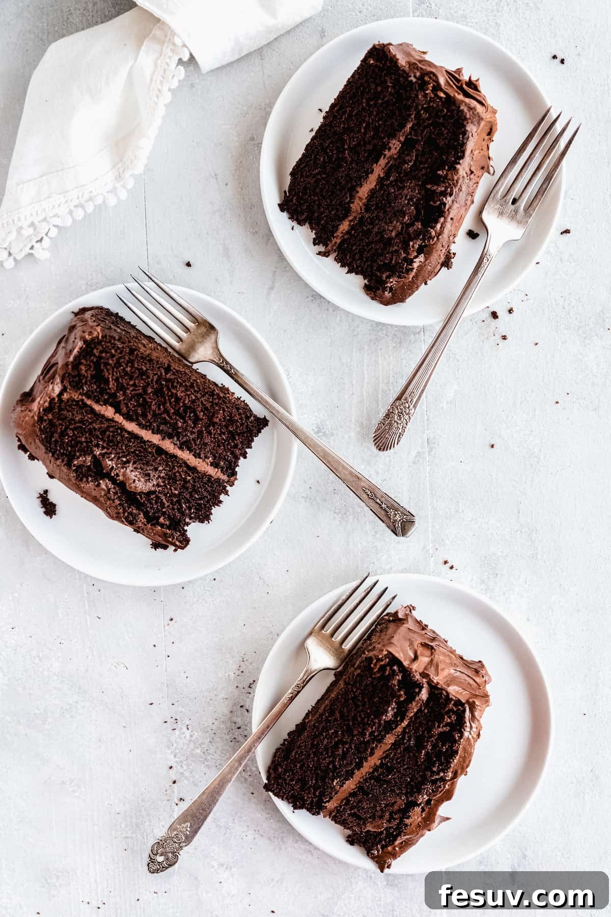 Three generous slices of homemade chocolate layer cake, ready to be enjoyed