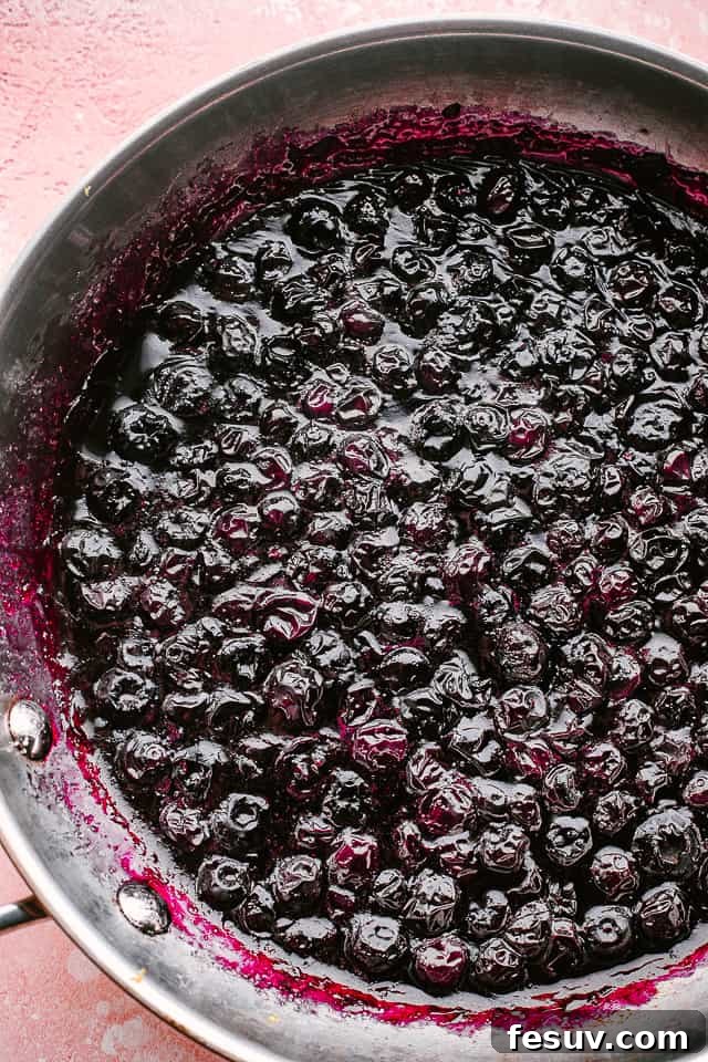 This easy blueberry sauce recipe is the perfect topping. Serve it over cheesecake, on waffles, mix it into yogurt, or spoon it onto ice cream! Fresh blueberries gently simmering in a pan, gradually transforming into a rich, thick, and bubbly sauce.