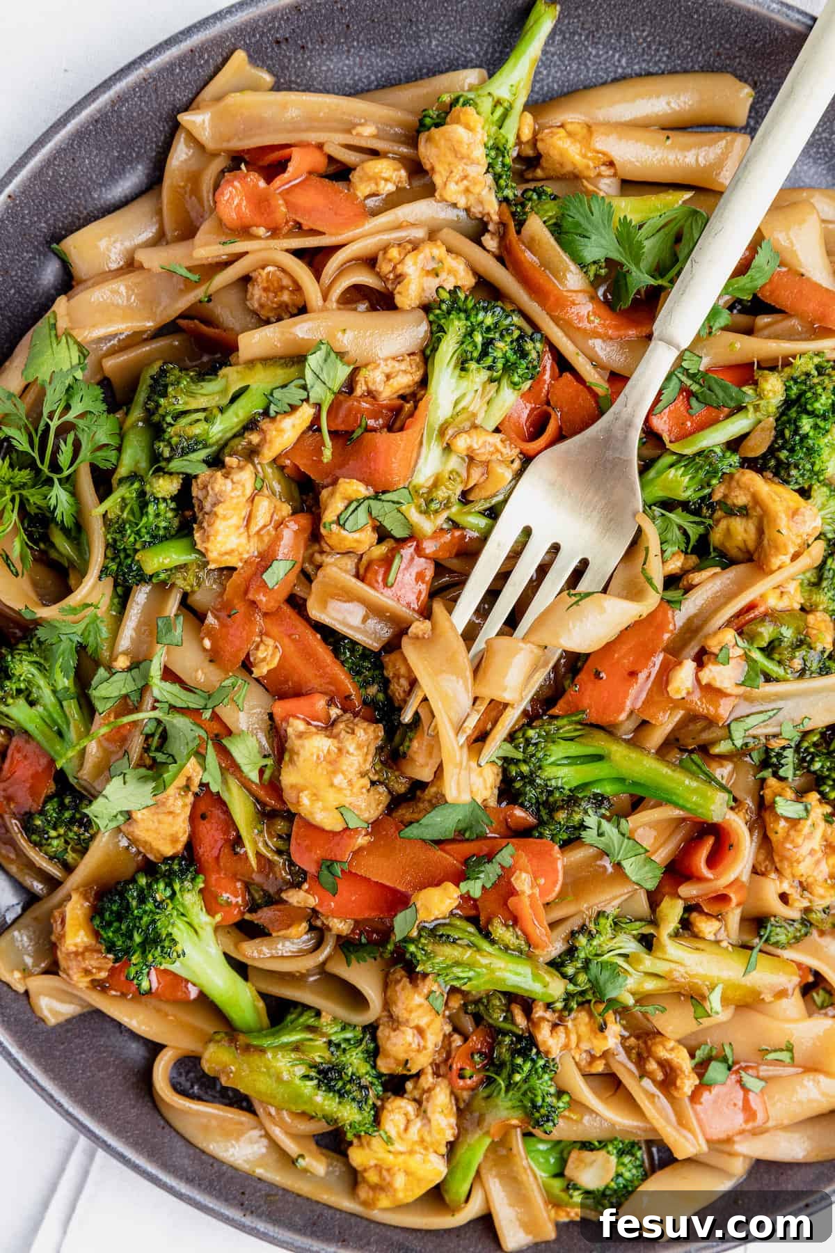 Thai Wide Noodle Perfection 4 A Fork Digging Into a Big Plate of Pad See Ew