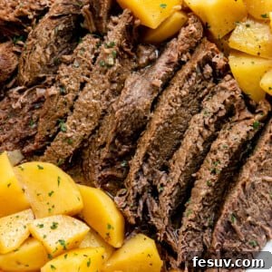 Pot roast with potatoes on a white plate