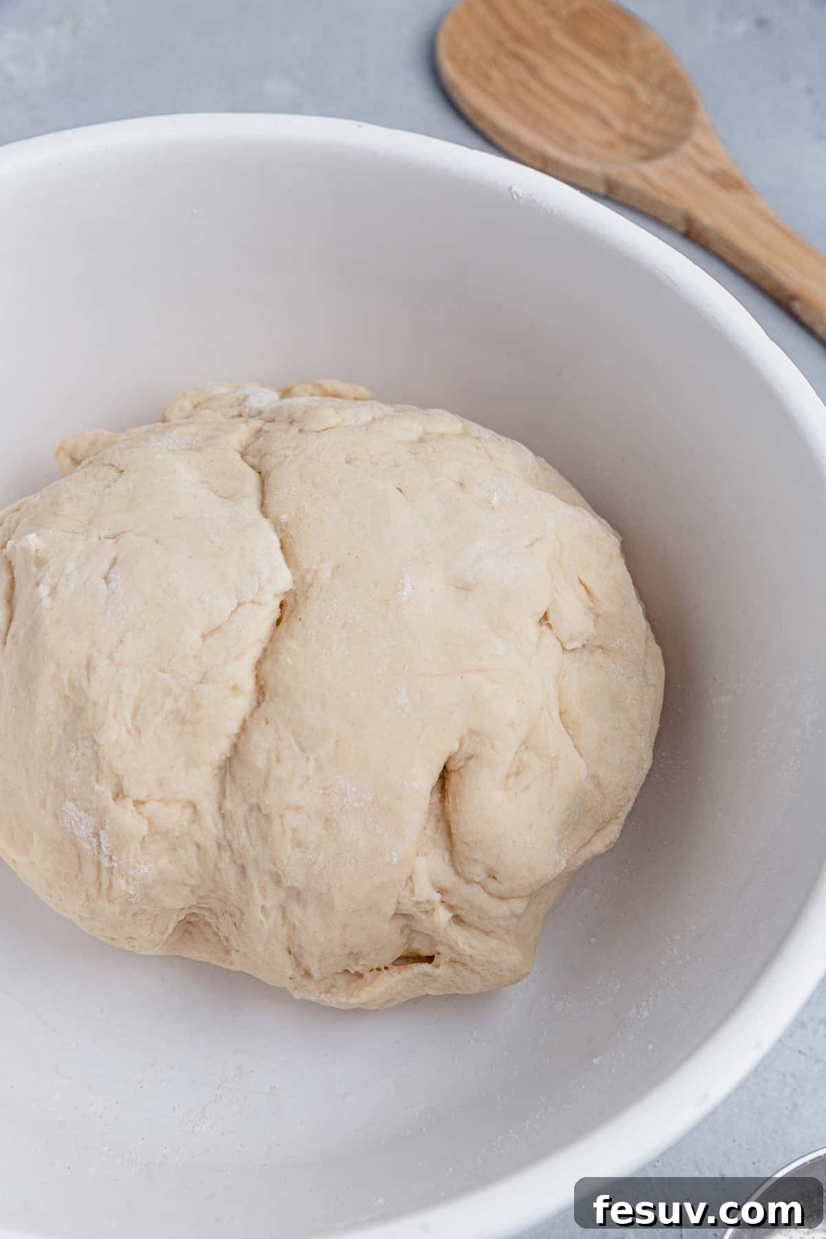 A bowl of soft, elastic pretzel dough, ready for the next step.